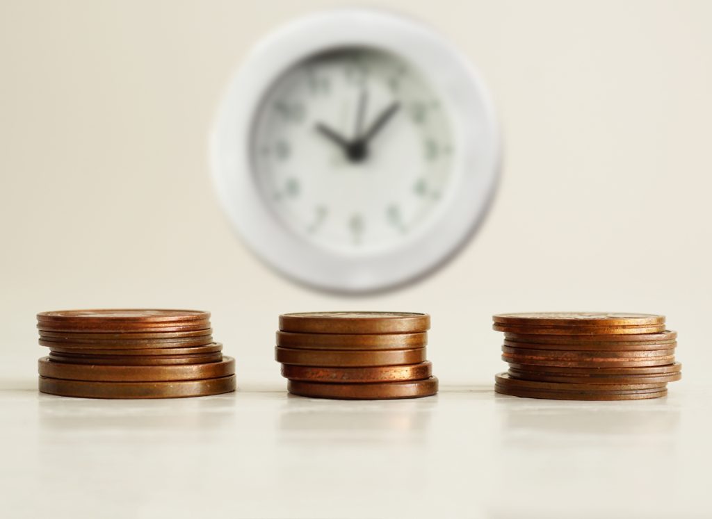 Image of three stacks of coins - representing decisions around cryptocurrency trading strategies